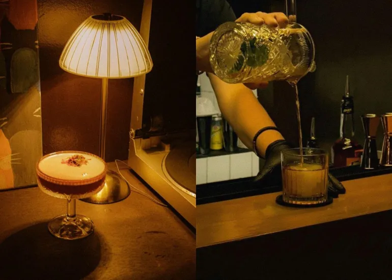 Elegant cocktail by lamplight and bartender crafting drinks at the bar